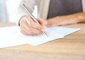 Employment Law image of person writing on a contract