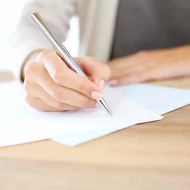 Employment Law image of person writing on a contract