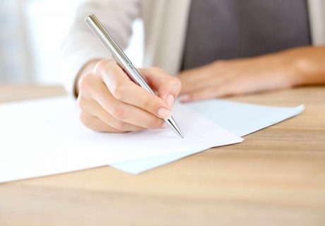 Employment Law image of person writing on a contract