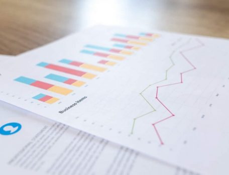 Graphic showing business spreadsheet data and graphs.