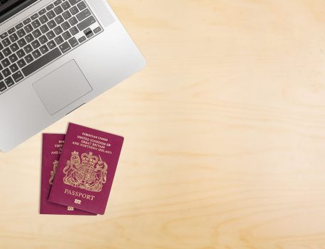 Desk with laptop and UK passports for Right to work