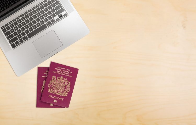 Desk with laptop and UK passports for Right to work