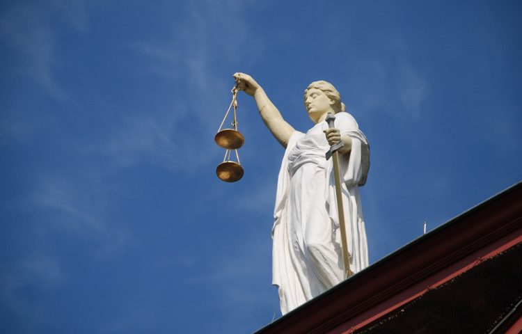 Picture of Justice with scales on top of building for reforms to fast track proceedings for litigation