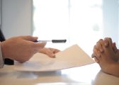 Image for white men sitting at table with paper and pen for the trust registration blog