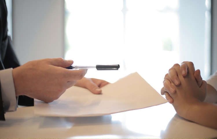 Image for white men sitting at table with paper and pen for the trust registration blog