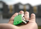 Picture of hand with house keys on green keyring for Conveyancing process blog