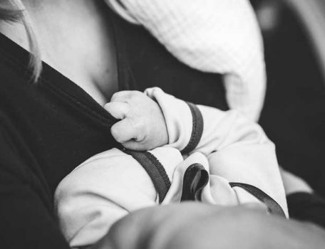 Breastfeeding facility blog image of woman holding a baby