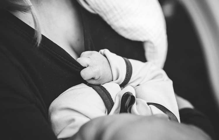 Breastfeeding facility blog image of woman holding a baby