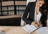 Persistent Absence Blog image showing a professional woman at at desk writing in a notepad