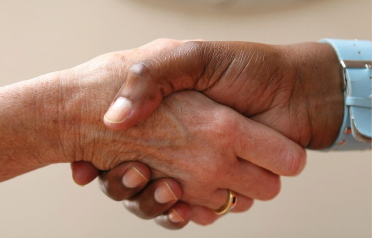 Image of two people shaking hands to represent the need for an Employment Contract, not just a handshake