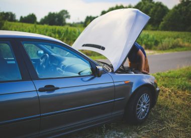 Image of a broken down car at the side of the road with the bonnet up and the driver looking under the bonnet for the Faulty Car After Purchase? Know Your Consumer Rights UK blog
